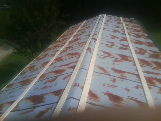 Rusted metal roof panels with new wood purlins before replacement — Storm Damage Roof Repair in Carrabelle by Roofing Brothers